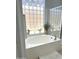 Bright bathroom with a soaking tub, glass block window, and separate glass shower enclosure at 14253 N Honeysuckle N Dr, Fountain Hills, AZ 85268