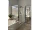 Bright bathroom featuring a glass-enclosed shower, soaking tub, and a tiled floor at 14253 N Honeysuckle N Dr, Fountain Hills, AZ 85268