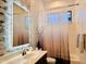 Well-lit bathroom with a single vanity, framed mirror, and a shower-tub combo at 14253 N Honeysuckle N Dr, Fountain Hills, AZ 85268