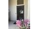 Elegant front door with decorative metalwork, adorned with a wreath and flanked by colorful floral arrangements at 14253 N Honeysuckle N Dr, Fountain Hills, AZ 85268