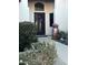 Charming home entrance with decorative wrought iron door, elegant plants, and beautiful landscaping at 14253 N Honeysuckle N Dr, Fountain Hills, AZ 85268