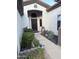 Inviting home entrance featuring a decorative wrought iron door and manicured landscaping at 14253 N Honeysuckle N Dr, Fountain Hills, AZ 85268