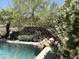 Resort-style pool area with tropical landscaping and a stone retaining wall at 14253 N Honeysuckle N Dr, Fountain Hills, AZ 85268