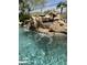 Tranquil pool with a unique rock waterfall feature and clear blue water at 14253 N Honeysuckle N Dr, Fountain Hills, AZ 85268