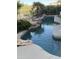 Beautiful swimming pool with rock waterfall and lush greenery, creating a serene and inviting backyard oasis at 14253 N Honeysuckle N Dr, Fountain Hills, AZ 85268