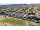Scenic aerial view of the neighborhood with a golf course, mountain views, and residential homes with pools at 1437 E Glenhaven Dr, Phoenix, AZ 85048