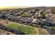 Aerial view showing neighborhood homes bordering the golf course with spectators watching golfers play at 1437 E Glenhaven Dr, Phoenix, AZ 85048