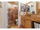 Updated bathroom showcasing a walk-in shower, stone tile accents, and stylish vessel sink at 1437 E Glenhaven Dr, Phoenix, AZ 85048