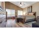 Spacious bedroom with vaulted ceiling, light brown walls, and wood-look tile flooring at 1437 E Glenhaven Dr, Phoenix, AZ 85048