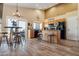 Bright kitchen with wood cabinets, modern appliances, and an adjacent breakfast nook with outdoor access at 1437 E Glenhaven Dr, Phoenix, AZ 85048