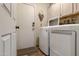 Convenient laundry room featuring a washer, dryer, cabinets, and access to outside through the door at 1437 E Glenhaven Dr, Phoenix, AZ 85048