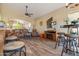 Open-concept living area featuring wood-look tile flooring and cozy leather furniture at 1437 E Glenhaven Dr, Phoenix, AZ 85048