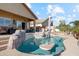 Backyard pool featuring rock accents, a swim-up table, and a covered patio with outdoor seating at 1437 E Glenhaven Dr, Phoenix, AZ 85048