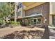 Elegant building entrance with lush landscaping and shade trees enhancing curb appeal at 16 W Encanto Blvd # 22, Phoenix, AZ 85003