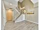 Bright entryway with gray wood-look tile, pendant lighting, and contemporary staircase at 16 W Encanto Blvd # 22, Phoenix, AZ 85003