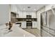 Modern kitchen with stainless steel appliances, white cabinets, and quartz countertops at 16 W Encanto Blvd # 22, Phoenix, AZ 85003