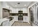 Updated kitchen featuring white cabinets, stainless steel appliances, and stylish backsplash at 16 W Encanto Blvd # 22, Phoenix, AZ 85003