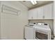 Functional laundry room with washer, dryer, and ample cabinet space at 16 W Encanto Blvd # 22, Phoenix, AZ 85003