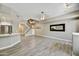 Spacious living room with gray wood floors, staircase, and modern lighting fixture at 16 W Encanto Blvd # 22, Phoenix, AZ 85003