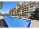 Inviting community pool surrounded by lounge chairs and lush landscaping, perfect for relaxation at 16 W Encanto Blvd # 22, Phoenix, AZ 85003