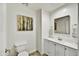 Clean powder room with white vanity, neutral paint, and decorative mirror at 16 W Encanto Blvd # 22, Phoenix, AZ 85003