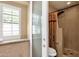The bathroom showcases tiled walls, a modern shower, and a window with plantation shutters, providing comfort and style at 1978 E Carver Rd, Tempe, AZ 85284