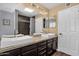 Bathroom featuring double sinks, modern fixtures, large mirror, and tile accents providing a clean and elegant design at 1978 E Carver Rd, Tempe, AZ 85284