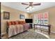 Bright bedroom featuring a daybed, ceiling fan, a desk, and natural light through a window with white shutters at 1978 E Carver Rd, Tempe, AZ 85284