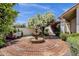 Charming courtyard featuring a red brick floor, a three-tier fountain, and lush landscaping at 1978 E Carver Rd, Tempe, AZ 85284
