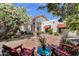 Charming courtyard featuring a red brick floor, a three-tier fountain, seating, and lush landscaping at 1978 E Carver Rd, Tempe, AZ 85284