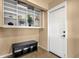 Functional entryway with a storage bench, a built-in shelf with decor, and a neutral color scheme at 1978 E Carver Rd, Tempe, AZ 85284