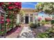 Charming home featuring a tile roof, lush landscaping, and a welcoming front entrance with a black door at 1978 E Carver Rd, Tempe, AZ 85284