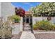Charming home featuring a tile roof, lush landscaping, and a beautiful black iron gate at 1978 E Carver Rd, Tempe, AZ 85284
