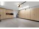 Spacious garage with epoxy floors, tons of storage cabinets, and access door at 1978 E Carver Rd, Tempe, AZ 85284