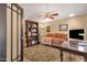 The home office features built-in bookshelves, a ceiling fan, and a comfortable daybed, perfect for work or relaxation at 1978 E Carver Rd, Tempe, AZ 85284