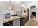 Bright kitchen featuring granite counters, stainless steel dishwasher and fixtures, and open access to the living room at 1978 E Carver Rd, Tempe, AZ 85284