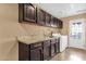 Well-equipped laundry room with modern cabinetry, countertops, sink, and appliances for efficient chores at 1978 E Carver Rd, Tempe, AZ 85284