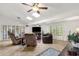 Spacious living room with tiled floors, ceiling fans, skylights, plantation shutters, and comfortable seating arrangement at 1978 E Carver Rd, Tempe, AZ 85284