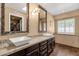 A luxurious bathroom features dual sinks, granite countertops, and decorative mirrors, adding a touch of elegance at 1978 E Carver Rd, Tempe, AZ 85284