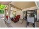 Well-designed covered patio with stylish seating around a fire pit, perfect for outdoor entertainment and relaxation at 1978 E Carver Rd, Tempe, AZ 85284