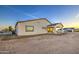 An expansive backyard features a covered patio, gravel landscaping, and a view of the desert landscape at 3033 N 367Th Ave, Tonopah, AZ 85354