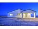 Exterior shot of a single-story home featuring a covered patio and desert landscaping at twilight at 3033 N 367Th Ave, Tonopah, AZ 85354