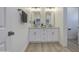 Modern bathroom featuring double sinks, white cabinets, and updated fixtures, creating a clean and stylish space at 3033 N 367Th Ave, Tonopah, AZ 85354