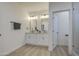Contemporary bathroom featuring dual sinks, modern fixtures, and a well-lit vanity with ample storage space at 3033 N 367Th Ave, Tonopah, AZ 85354