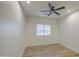 Neutral bedroom featuring wood-look tile flooring, ceiling fan, and bright natural light at 3033 N 367Th Ave, Tonopah, AZ 85354
