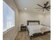 Comfortable bedroom with a ceiling fan, wood-look floors, and a large window offering natural light at 3033 N 367Th Ave, Tonopah, AZ 85354