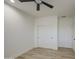 Clean bedroom with wood-look floors, ample closet space, ceiling fan, and neutral walls at 3033 N 367Th Ave, Tonopah, AZ 85354