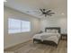 Serene bedroom featuring wood-look flooring, a ceiling fan, and a bright window providing natural light at 3033 N 367Th Ave, Tonopah, AZ 85354