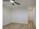 Spacious bedroom with tile floors, ceiling fan, and convenient door access at 3033 N 367Th Ave, Tonopah, AZ 85354