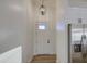 Inviting entryway with modern light fixture and a stainless steel refrigerator nearby at 3033 N 367Th Ave, Tonopah, AZ 85354